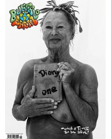 Black-and-white image of an older adult woman with dreadlocks holding a book titled 'Diary one,' with 'Buffalo Earth' logo.
