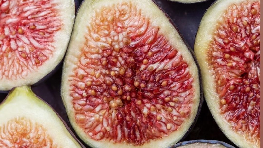 Close-up photograph of halved figs showcasing their intricate internal structure and vibrant colors; a visually appealing still life.