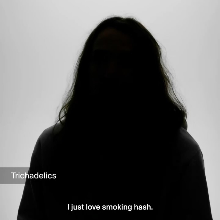 Dark silhouette of a person with long hair against a white background, wearing a hoodie. Minimalist portrait with stark contrast.