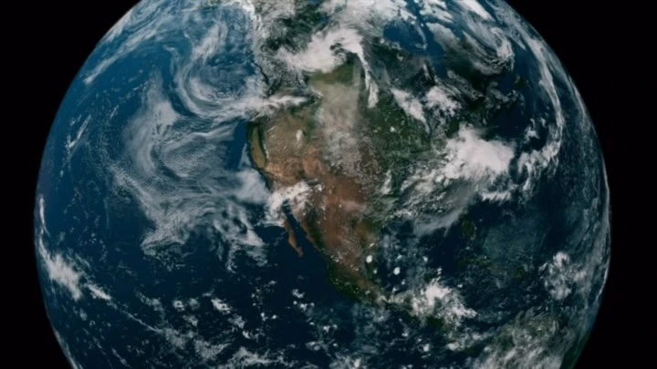 Satellite view of planet Earth showing North America, oceans, cloud cover, and dark space background, providing a global perspective.