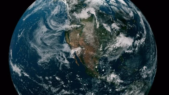 Dramatic full Earth view from space showcasing North America under scattered clouds, set against a black cosmic background.