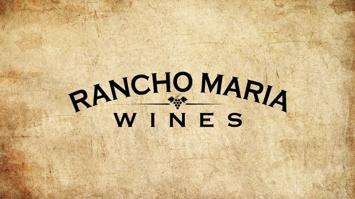 Rancho Maria Wines logo on a textured beige background featuring a grape cluster icon above the word 'Wines' in black typeface.