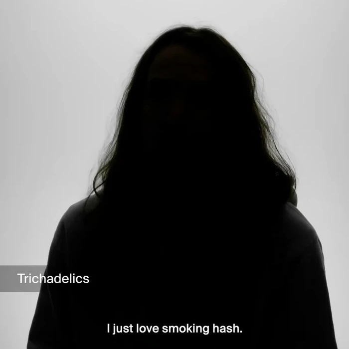 Silhouetted person with long hair against a bright white background with overlay text