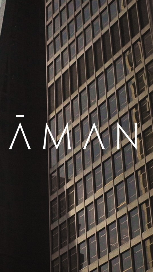 Modern architectural design featuring a tall building with geometric window patterns and contrasting dark shadowed structure in an urban setting.