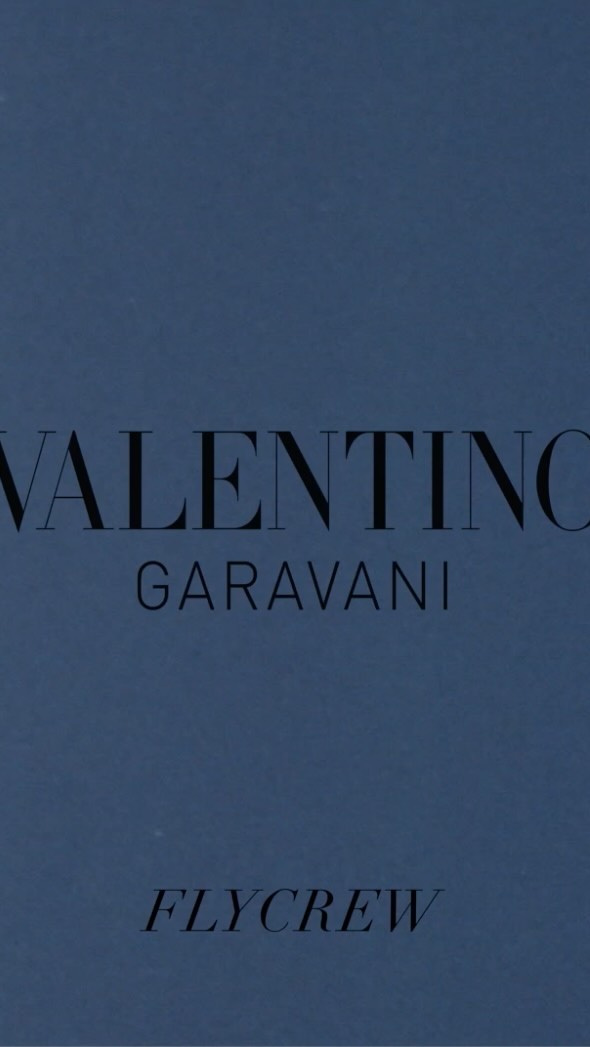 Vertical product shot of a light blue Valentino Garavani box featuring black text. The box is for Flycrew.