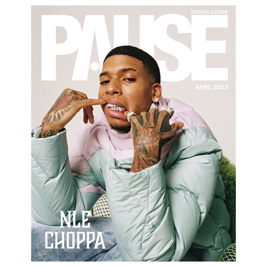 Magazine cover featuring a portrait of a young adult male wearing a puffy jacket and grill, posing with his hands near his face.
