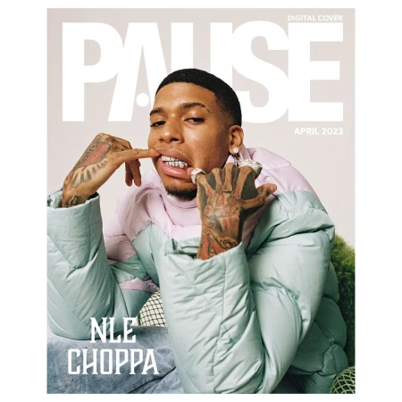Magazine cover featuring a portrait of a young adult male wearing a puffy jacket and grill, posing with his hands near his face.