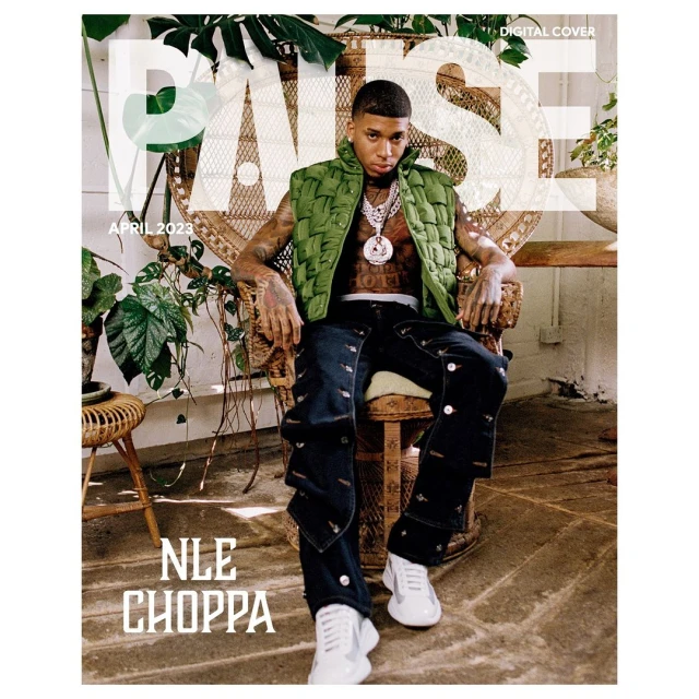 NLE Choppa on a magazine cover wearing a green vest and jeans, sitting on a wicker chair surrounded by plants. 'PAUSE' is printed on top.