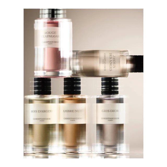 Multiple perfume bottles in a studio shot featuring different scents from Christian Dior, including Rouge Trafalgar and Jasmin Des Anges.