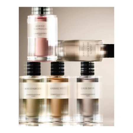 Multiple perfume bottles in a studio shot featuring different scents from Christian Dior, including Rouge Trafalgar and Jasmin Des Anges.