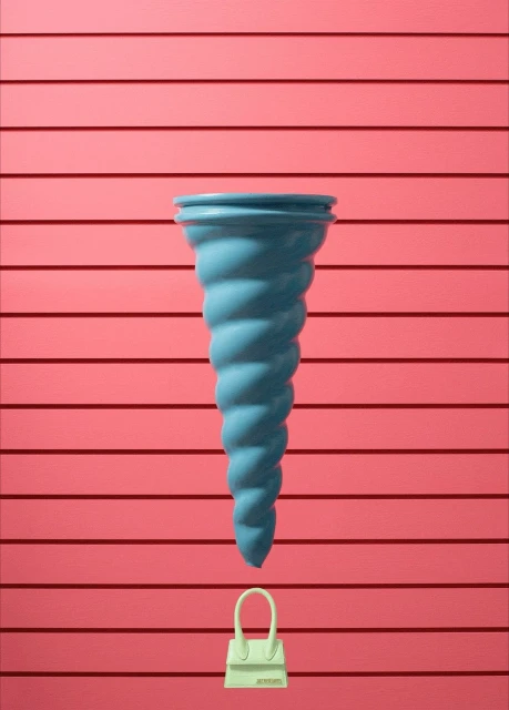 Conceptual still life with a blue vase and small, off-white purse against a backdrop of coral pink horizontal planks.