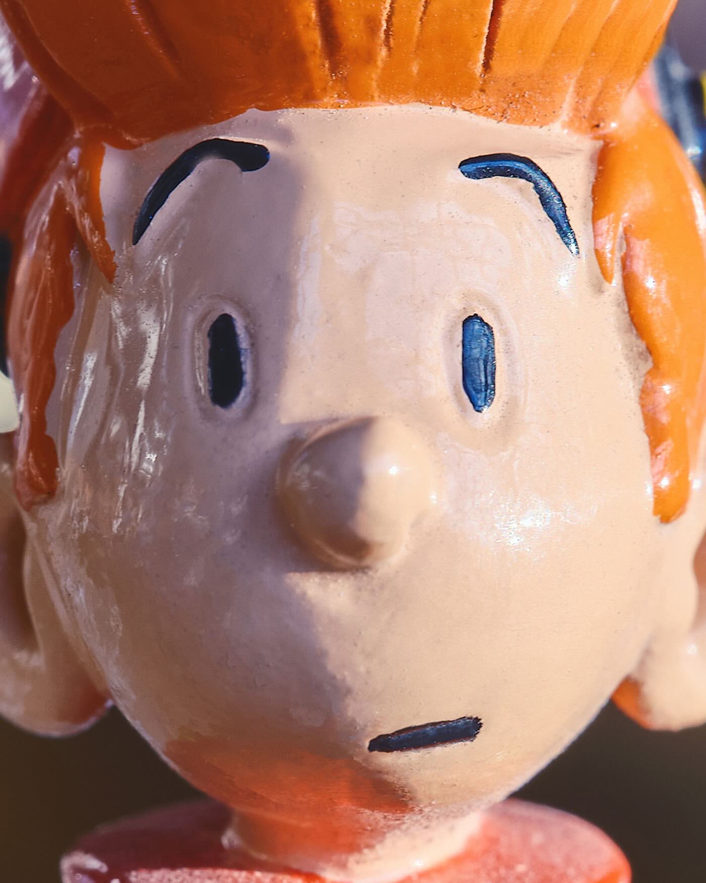 Close-up of a cartoon character head with orange hair, fair skin, and a concerned expression, showcasing painting or animation techniques.