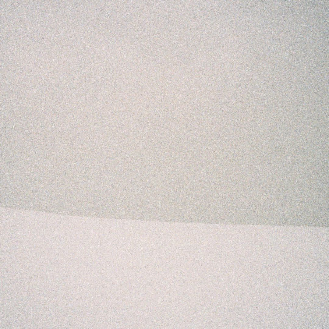 Minimalist aesthetic featuring two-tone off-white surface, creating a serene and clean visual appeal with a subtle line.