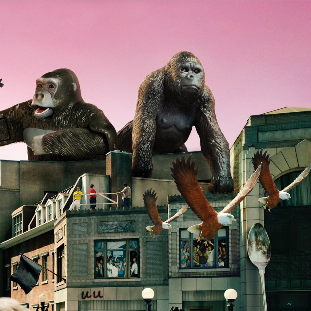 Digital art featuring toy gorillas looming over a cityscape with people on rooftops, eagles flying, and a giant spoon; surreal and whimsical.