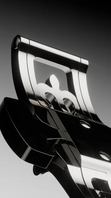 Close-up of a shiny chrome metal decorative piece featuring fleur-de-lis designs against a gradient gray background, showcasing luxury and artistry.