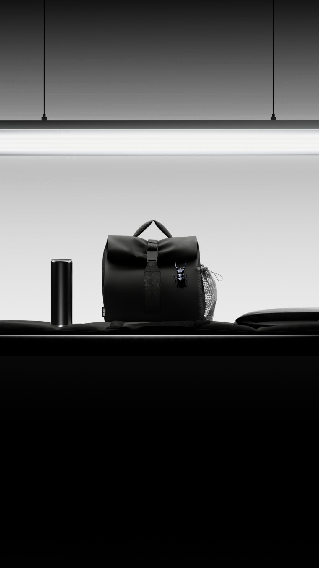 Black backpack and thermos sit on a table in a studio with black and white colors, minimalist composition, and sleek design.