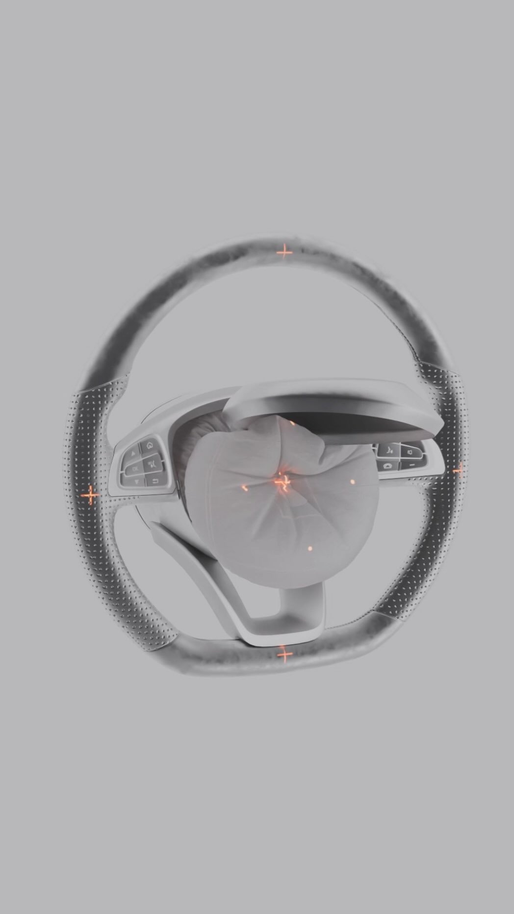 Airbag deployed inside a car's steering wheel, showcasing automotive safety technology with the interior in a neutral grey color scheme.