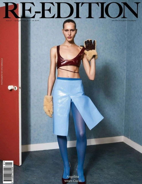 Magazine cover featuring a model wearing a brown top, light blue skirt, and blue tights, with furry gloves and a red door in the background.
