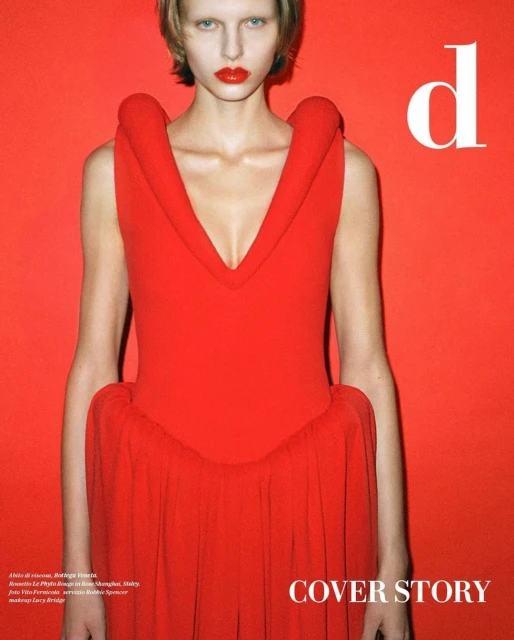 A fashion portrait features a blonde-haired woman in a red dress against a red background with white text and a striking, modern aesthetic.