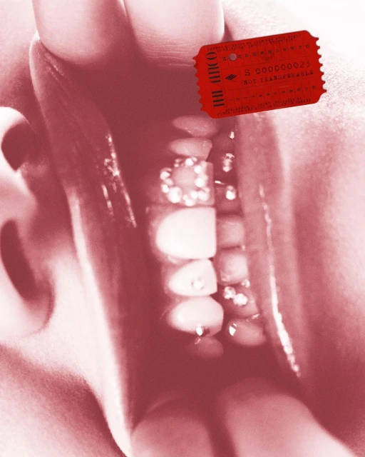 Close-up of a person's mouth with decorative teeth and a red ticket, capturing beauty in a slightly surreal, high-contrast composition.