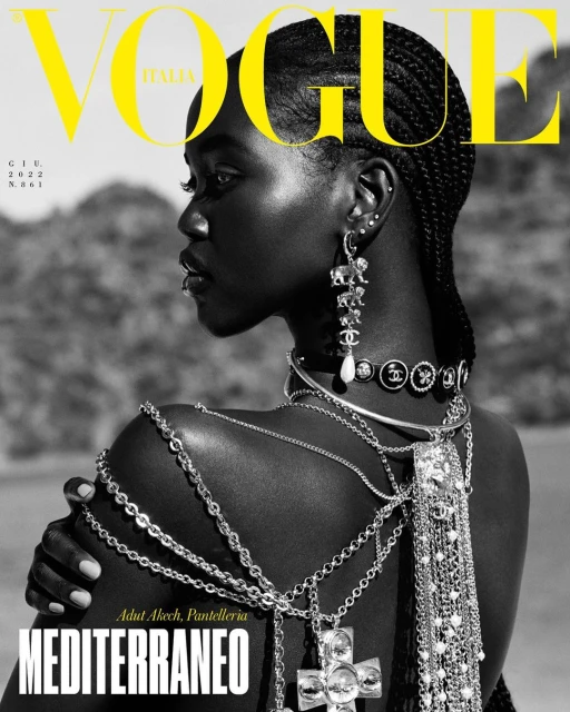 Vogue Italia cover featuring a Black woman in profile, adorned with jewelry, set against a soft-focus outdoor backdrop.