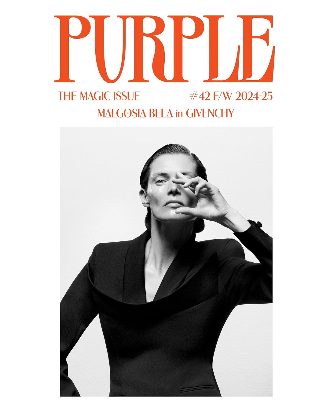Magazine cover featuring an adult woman in a black top, contrasted against a white background. The cover features the magazine's title in orange text.