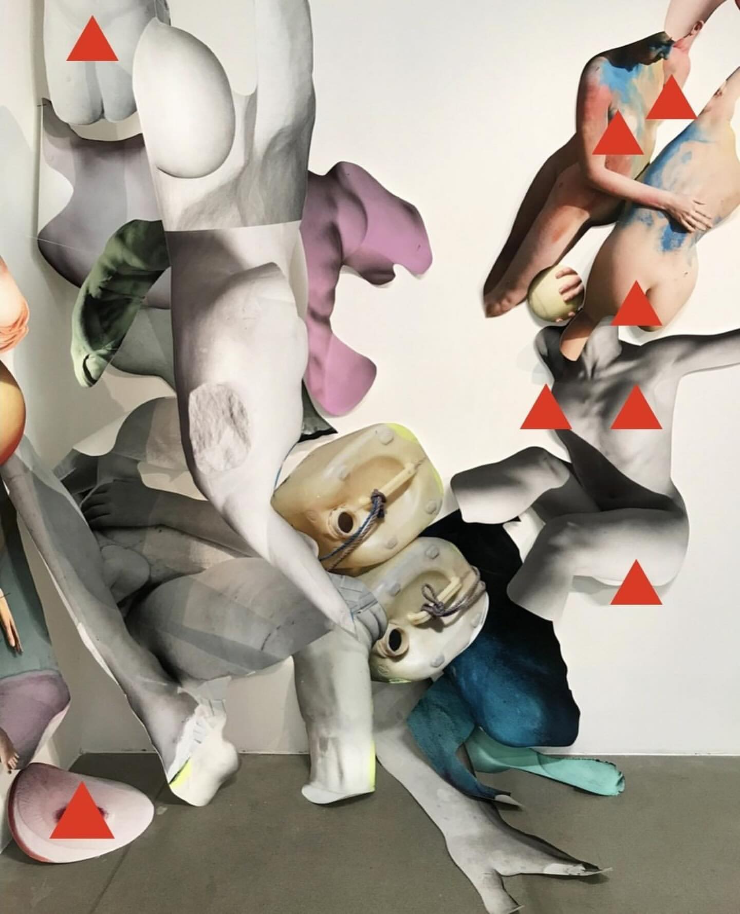 Abstract art featuring dismembered human forms in a collage style with gray, purple, and blue tones, accented by superimposed red triangles.