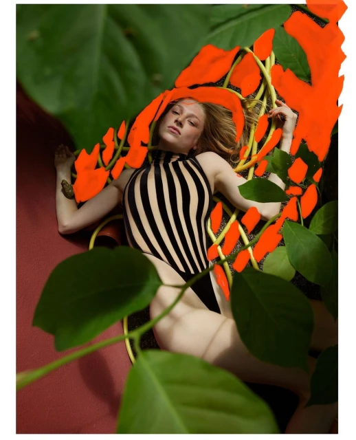 Adult female in striped swimsuit relaxes in foliage, graphic shapes, bright colors, and indoor setting, vibrant and youthful editorial style.