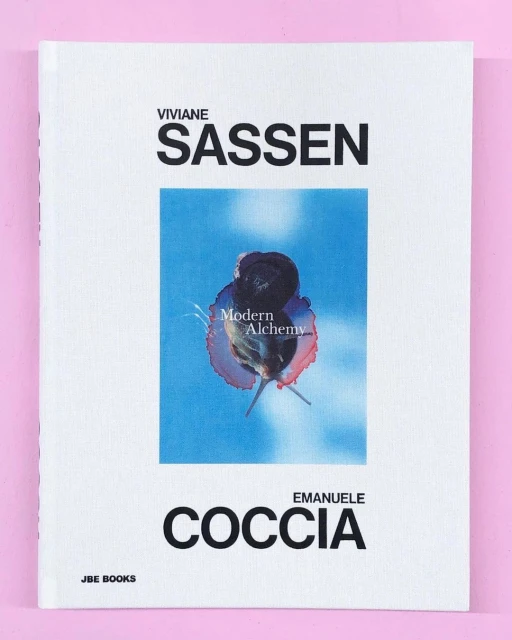The cover of the book 'Viviane Sassen, Emanuele Coccia, JBE BOOKS' features a blue-toned image with the words 'Modern Alchemy'.