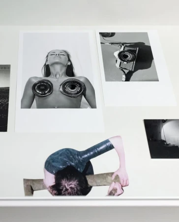 Monochrome collage featuring two photographic prints: one of a person and one of a camera, alongside an assemblage with a person.