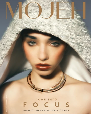 Magazine cover featuring a female model in a textured hood and necklace, under the 'MOJEH' title, with 'COME INTO FOCUS' as text.