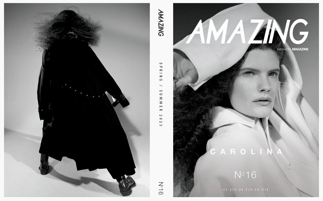 Fashion magazine cover featuring a person in a white coat and a person in a long black coat with silver embellishments on a light grey background.
