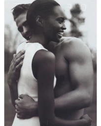 Black and white portrait of a smiling woman embracing a man outdoors, captured by photographer Walter Chin.