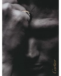 Close-up monochrome portrait of a man touching his forehead, wearing a gold ring, photographed by Walter Chin.