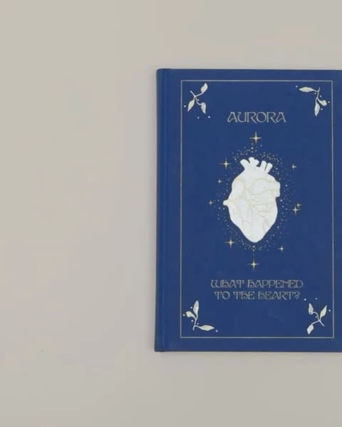 Book cover featuring a stylized anatomical heart surrounded by stars, with the title 'Aurora' and subtitle 'What Happened To The Heart?'