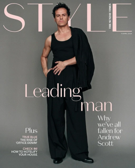 Andrew Scott featured on magazine cover in a studio shot. He wears a black tank top, suit pants, and drapes jacket over shoulder.