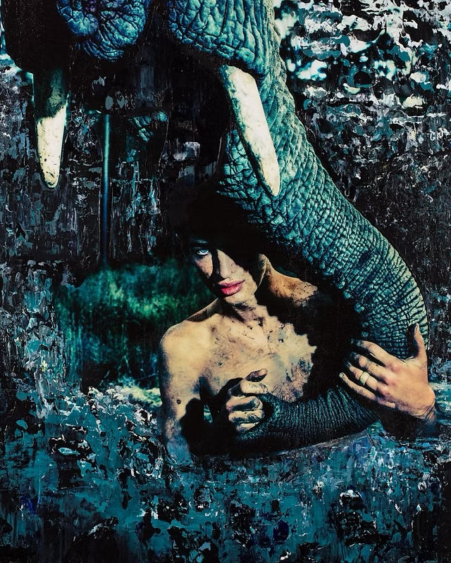 Painted portrait of a shirtless man next to an elephant tusk in a lush, dark environment. The scene is richly textured with deep blues and greens.