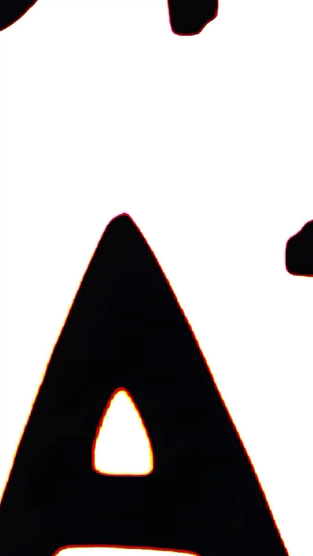 Close-up shot of a black uppercase letter 'A' with an orange glow on a bright white background in a high-contrast studio setting.
