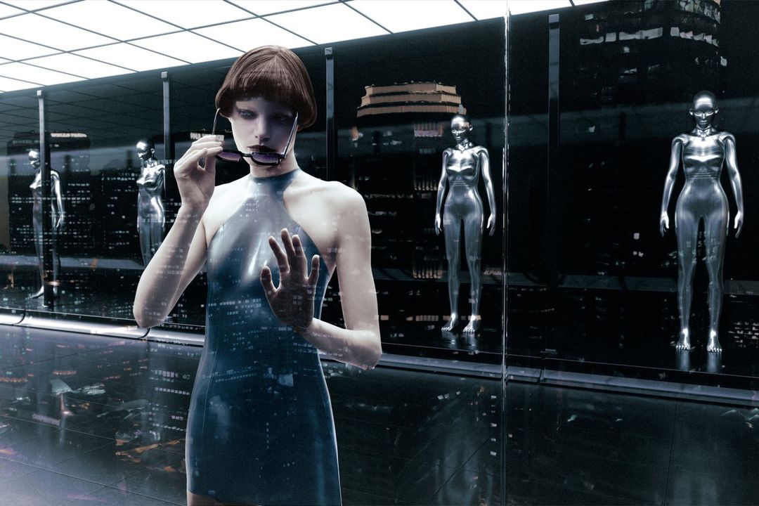 Woman in a futuristic setting, wearing a dress and sunglasses, standing near mannequins and glass panels reflecting city lights.