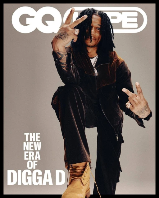 Digga D poses in a magazine cover-style image, wearing a brown jacket, dark pants, and tan boots, with GQ logo, text in frame.