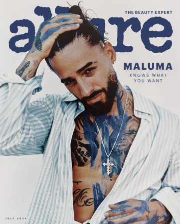 Allure magazine cover featuring Maluma with blue paint accents, striped shirt, and silver cross necklace against a cream backdrop.