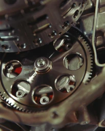 Macro shot of mechanical motorcycle engine gears and metal components by William Lacalmontie in Paris