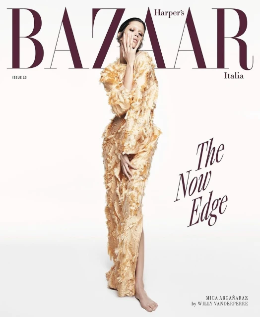 Harper's Bazaar Italia cover featuring a person in a gold, textured gown, posing against a bright backdrop, with magazine text overlay.
