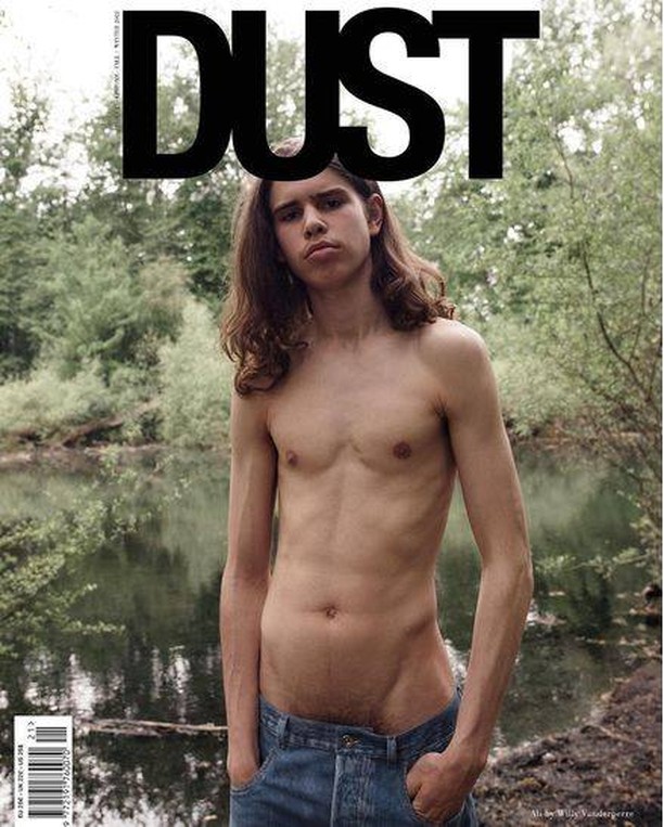 Magazine cover featuring a shirtless young man with long hair and jeans standing in a verdant, watery landscape under the DUST logo.