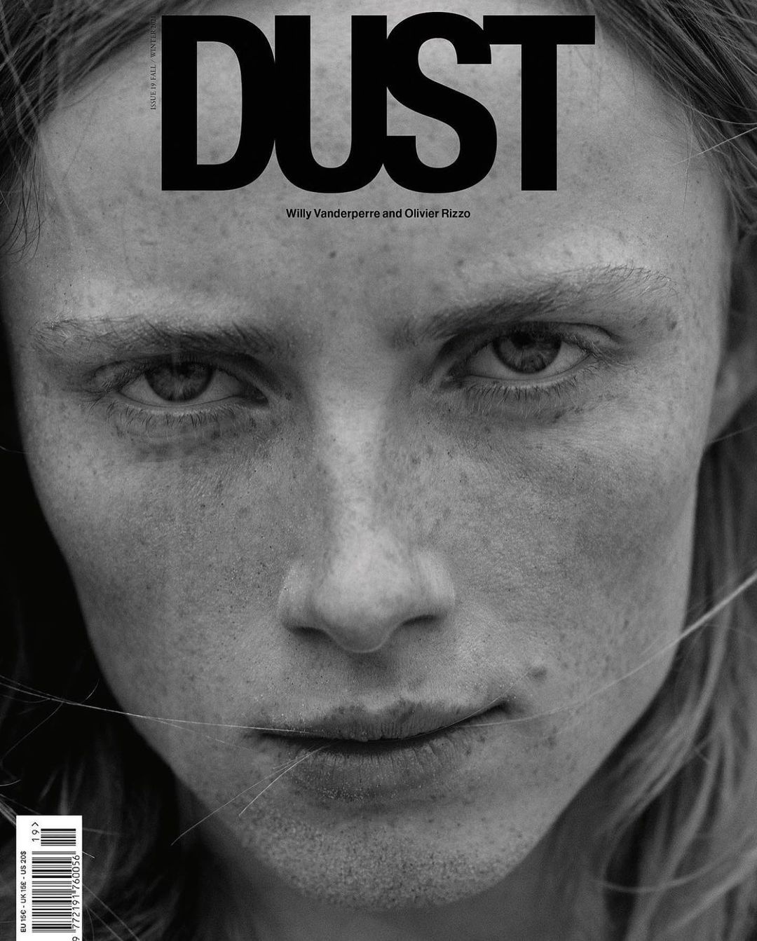Black and white portrait of a freckled person on the cover of Dust magazine, featuring a close-up of a person's face and shoulders.