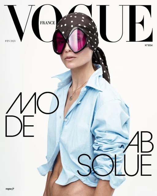 Vogue France cover featuring a model in a light blue shirt, polka dot scarf, and oversized sunglasses against a white backdrop.