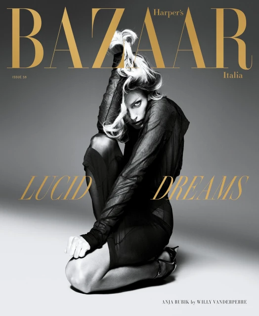 Harper's Bazaar Italia magazine cover featuring Anja Rubik in a sheer black outfit, kneeling against a gray backdrop with gold text overlay.