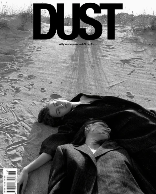 Black and white magazine cover featuring two women laying on a sandy surface, with the bold title 'DUST' printed at the top.
