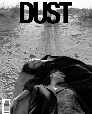 Black and white magazine cover featuring two women laying on a sandy surface, with the bold title 'DUST' printed at the top.