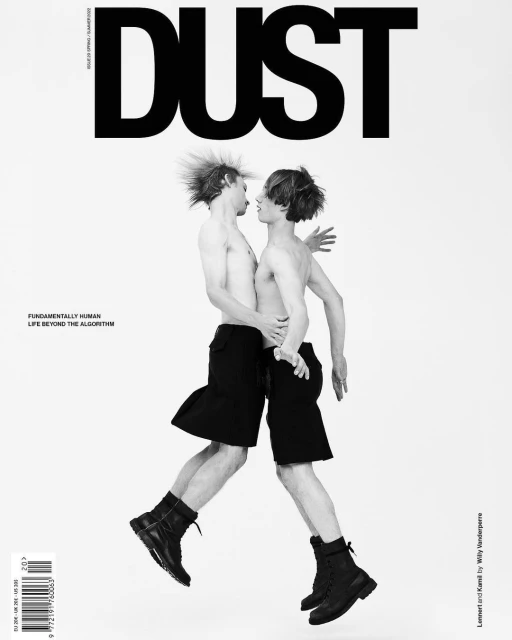Dust Magazine cover with two shirtless young men in black shorts and boots jumping against a white background with large magazine title.